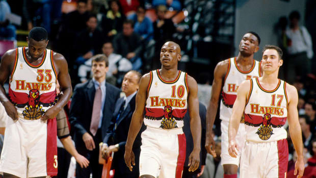Feb 14, 1997; Atlanta, GA, USA; FILE PHOTO; Atlanta Hawks guard Mookie Blaylock (10), Tyrone Corbin (33), Jon Barry (17) and Dikembe Mutombo (55) against the Chicago Bulls at the Omni.